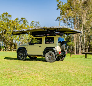 small rooftop tent on yellow car outdoors